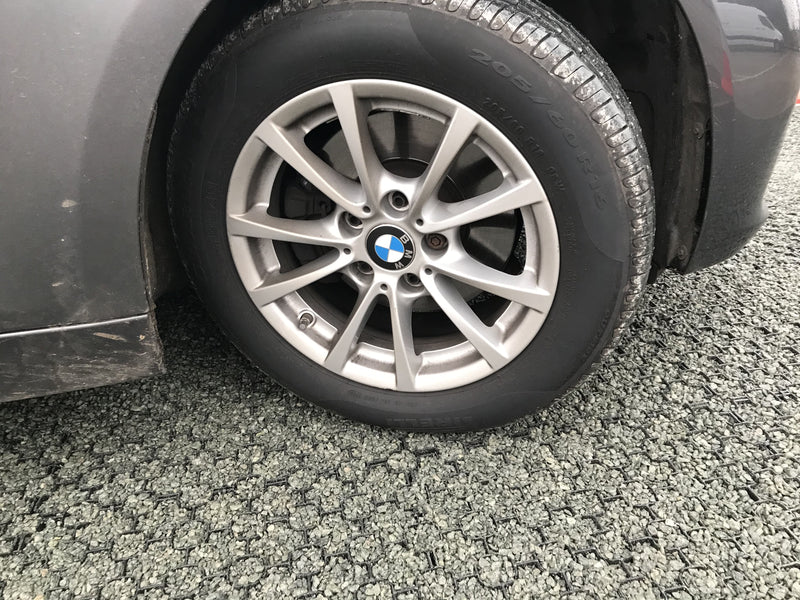 Load image into Gallery viewer, Terram Bodpave 40 used with gravel to make a craparck surface. A BMW car wheel can be seen on the surface.