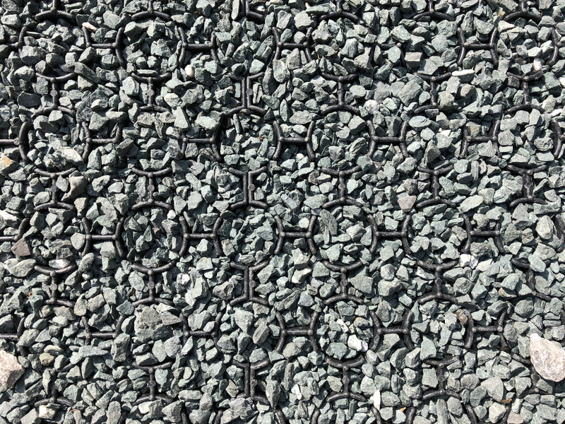 Load image into Gallery viewer, Close-up of black Bodpave 85 paving grid system used filled with gravel.