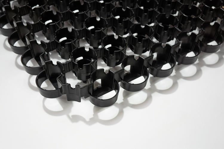 Close-up of Bodpave 85 black permeable paving grid on a white background